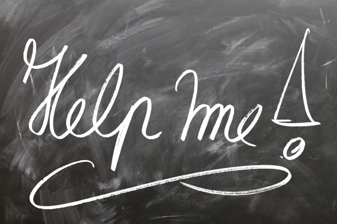 the words "help me" written on a chalkboard
