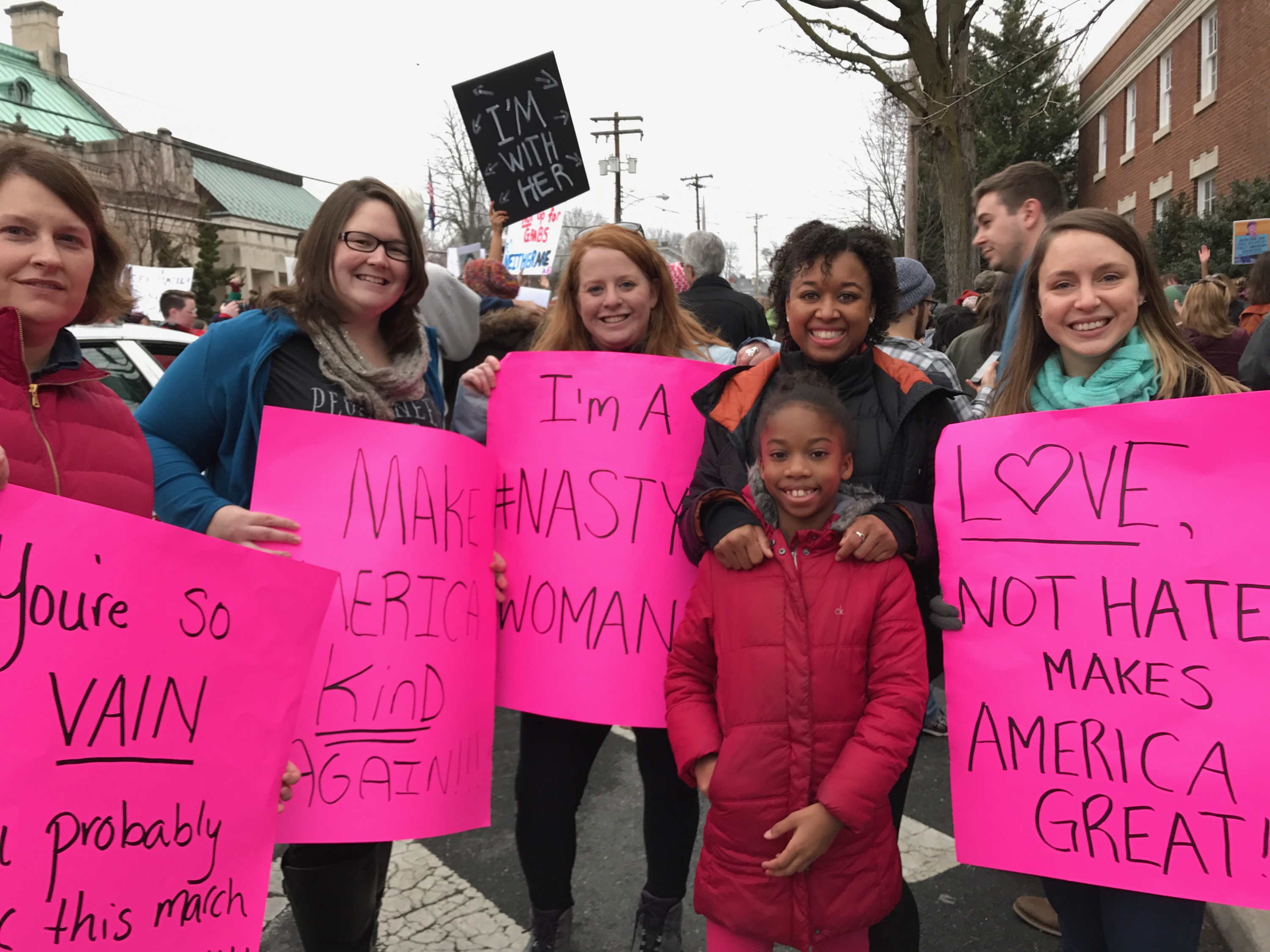 5 women posing for a picture with protest signs for civil rights